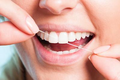 Close up of woman flossing her teeth, Garran ACT
