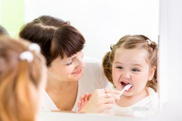 mother and young girl brushing teeth in garran