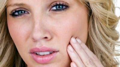 Woman holding mouth in tooth pain, Garran ACT