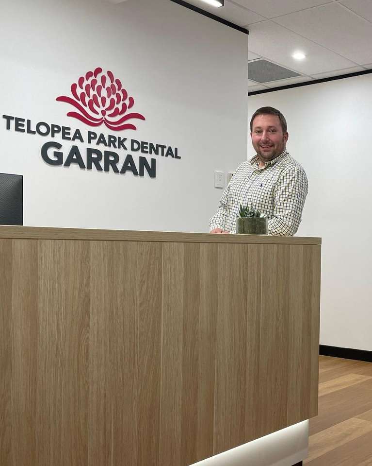Dr. Eric Kropinak stands in front of a desk, Garran ACT